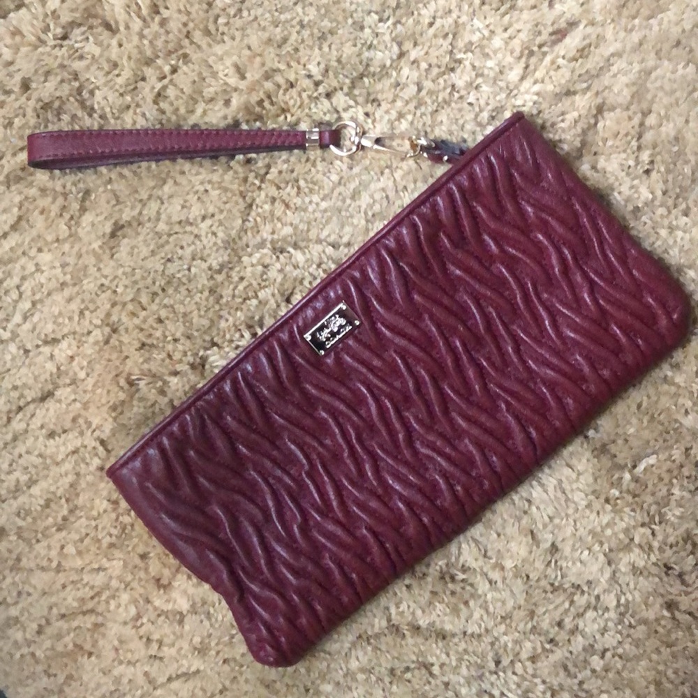 coach zipper clutch. Embossed gorgeous design . Like new never carried.